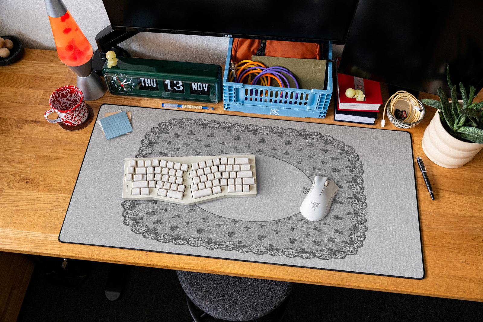 Oval Veil desk mat in Porcelain, shown on a styled desk setup