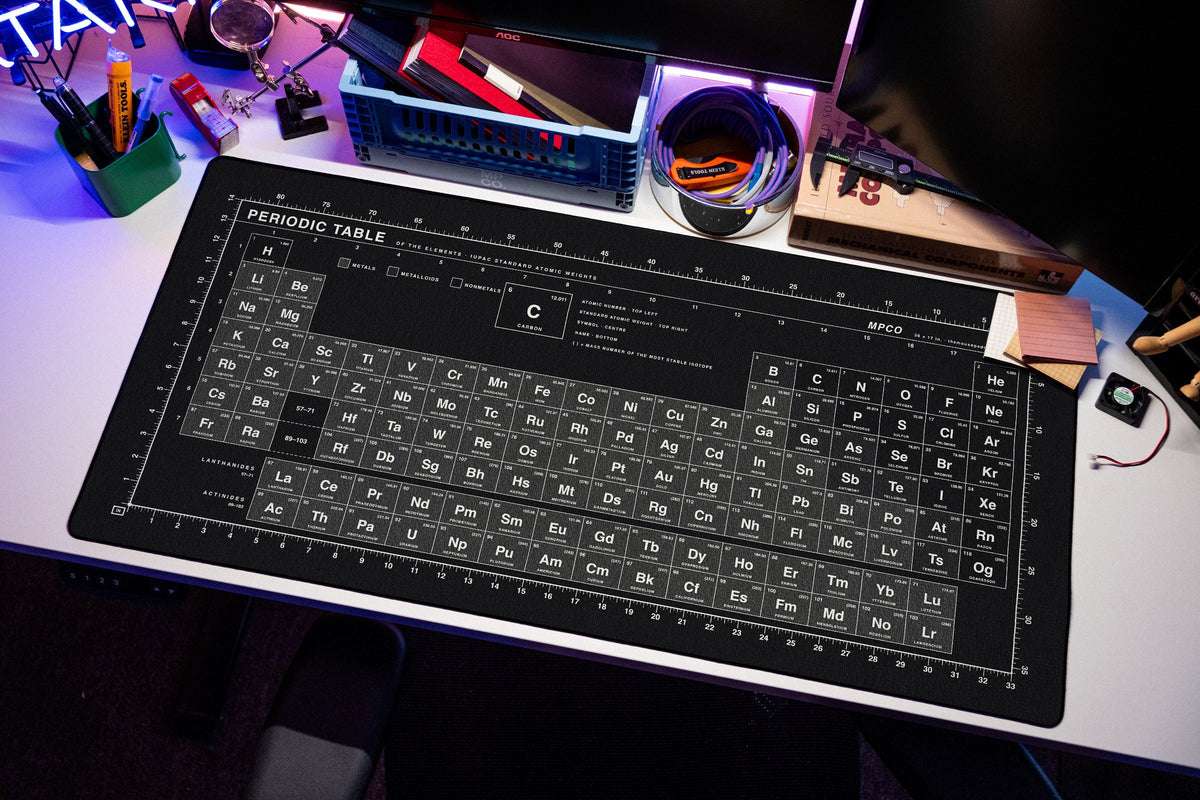 Periodic Table Pad desk mat in Black / White, shown on a styled desk setup