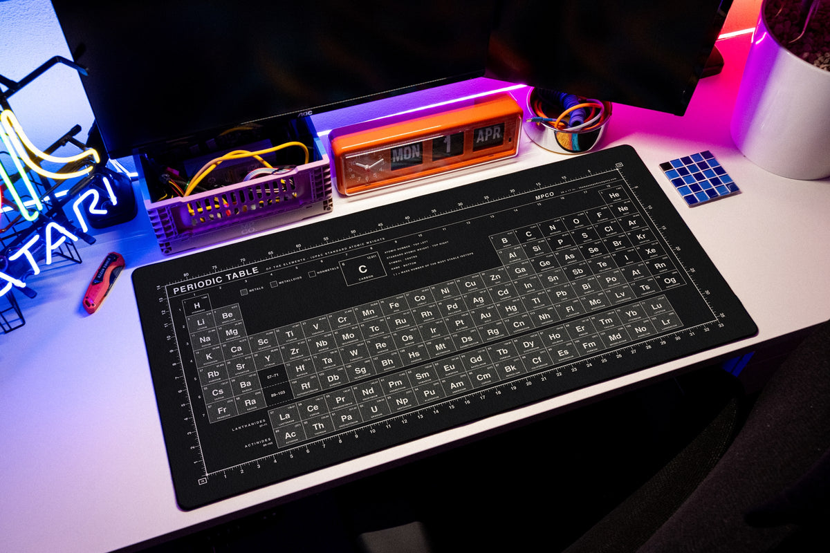 Periodic Table Pad desk mat in Black / White, shown on a styled desk setup