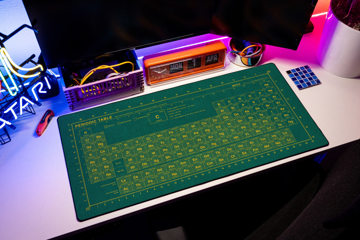 Periodic Table Pad desk mat in Green / Yellow, shown on a styled desk setup