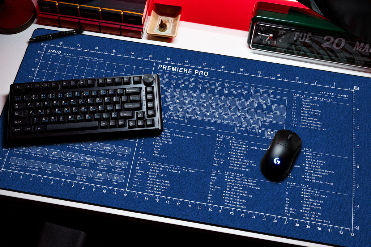 Premiere Pro Shortcuts Pad (macOS) desk mat in Blue / White, shown on a styled desk setup
