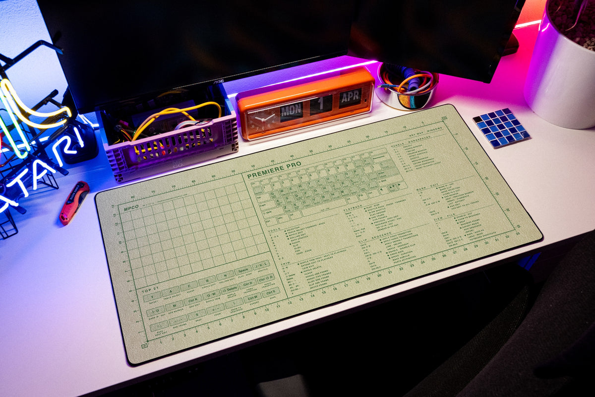 Premiere Pro Shortcuts Pad (Windows) desk mat in Buff / Green, shown on a styled desk setup