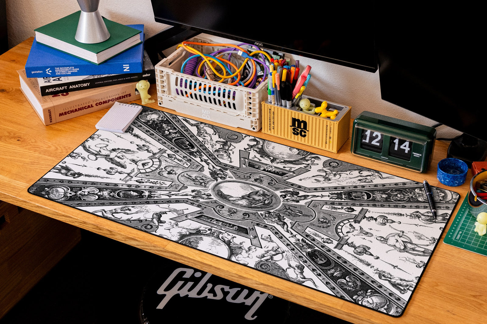 Reclining Allegory desk mat in Dither, shown on a styled desk setup