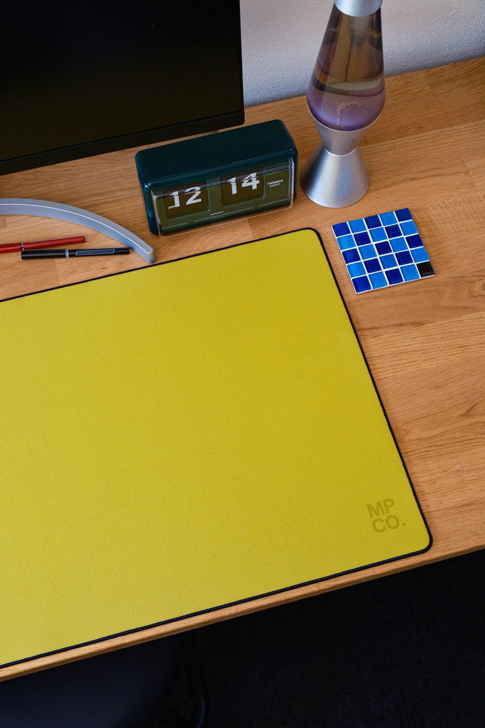 Solid Colors 2026 Summer desk mat in Lemon, shown on a styled desk setup