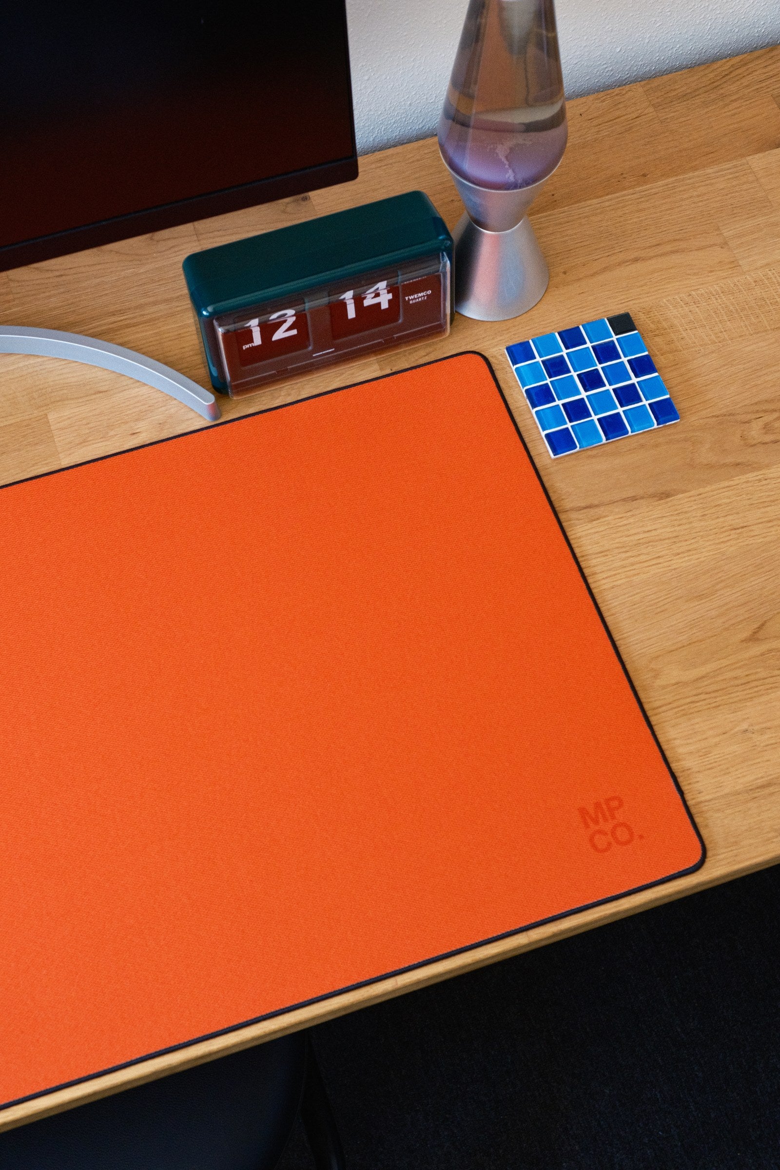 Solid Colors 2026 Summer desk mat in Orange, shown on a styled desk setup