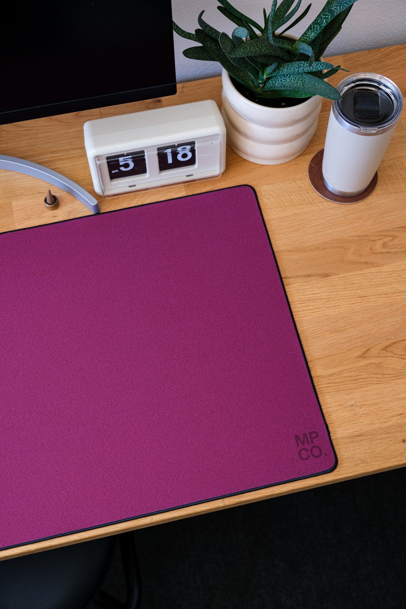 Solid Colors 2026 Summer desk mat in Orchid, shown on a styled desk setup