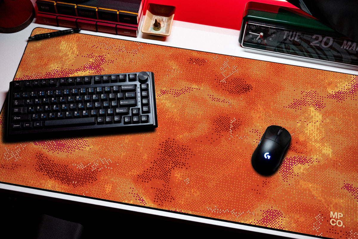 Stitch Grid desk mat in Cinder, shown on a styled desk setup