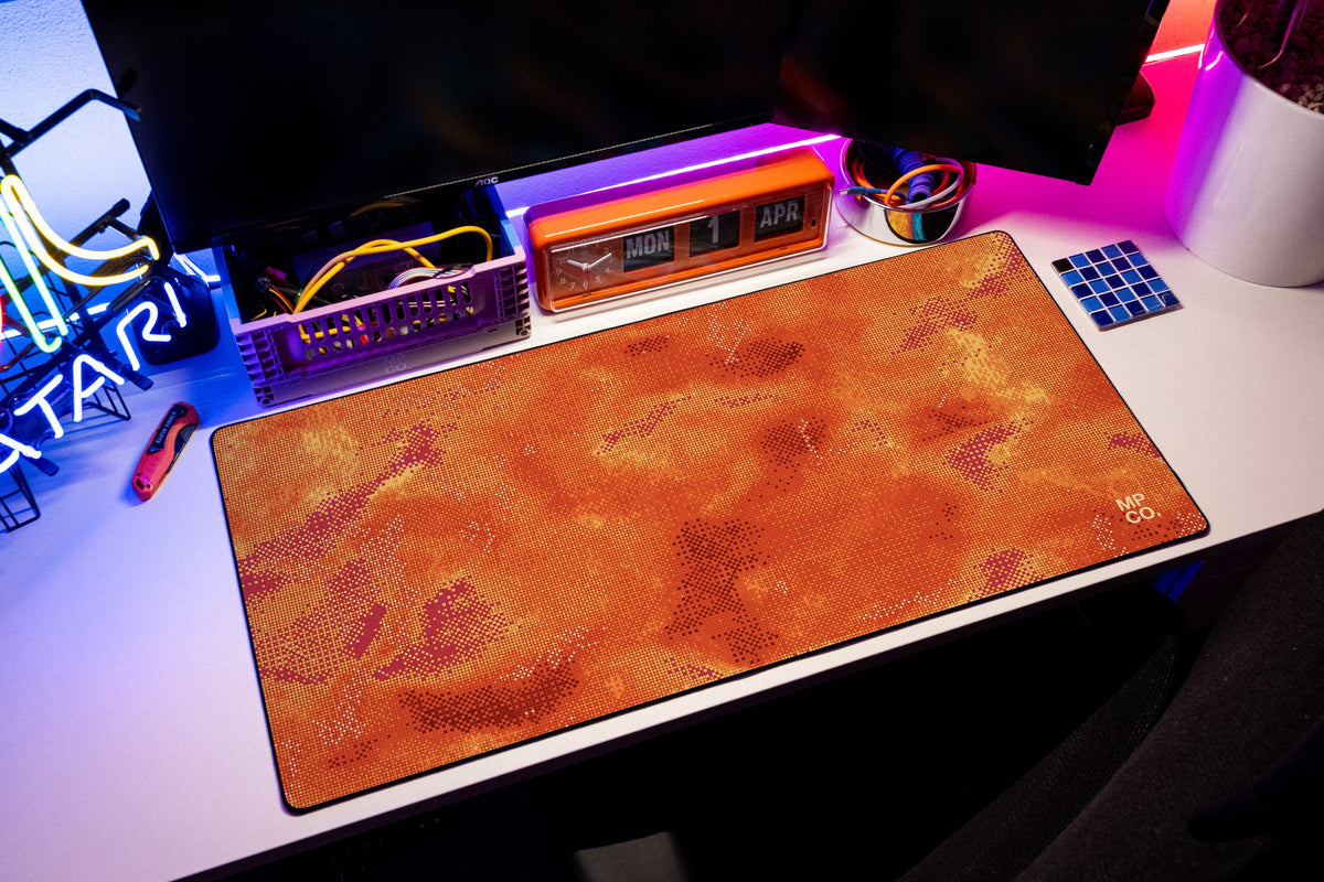 Stitch Grid desk mat in Cinder, shown on a styled desk setup