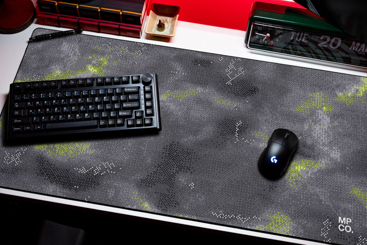 Stitch Grid desk mat in Graphite, shown on a styled desk setup