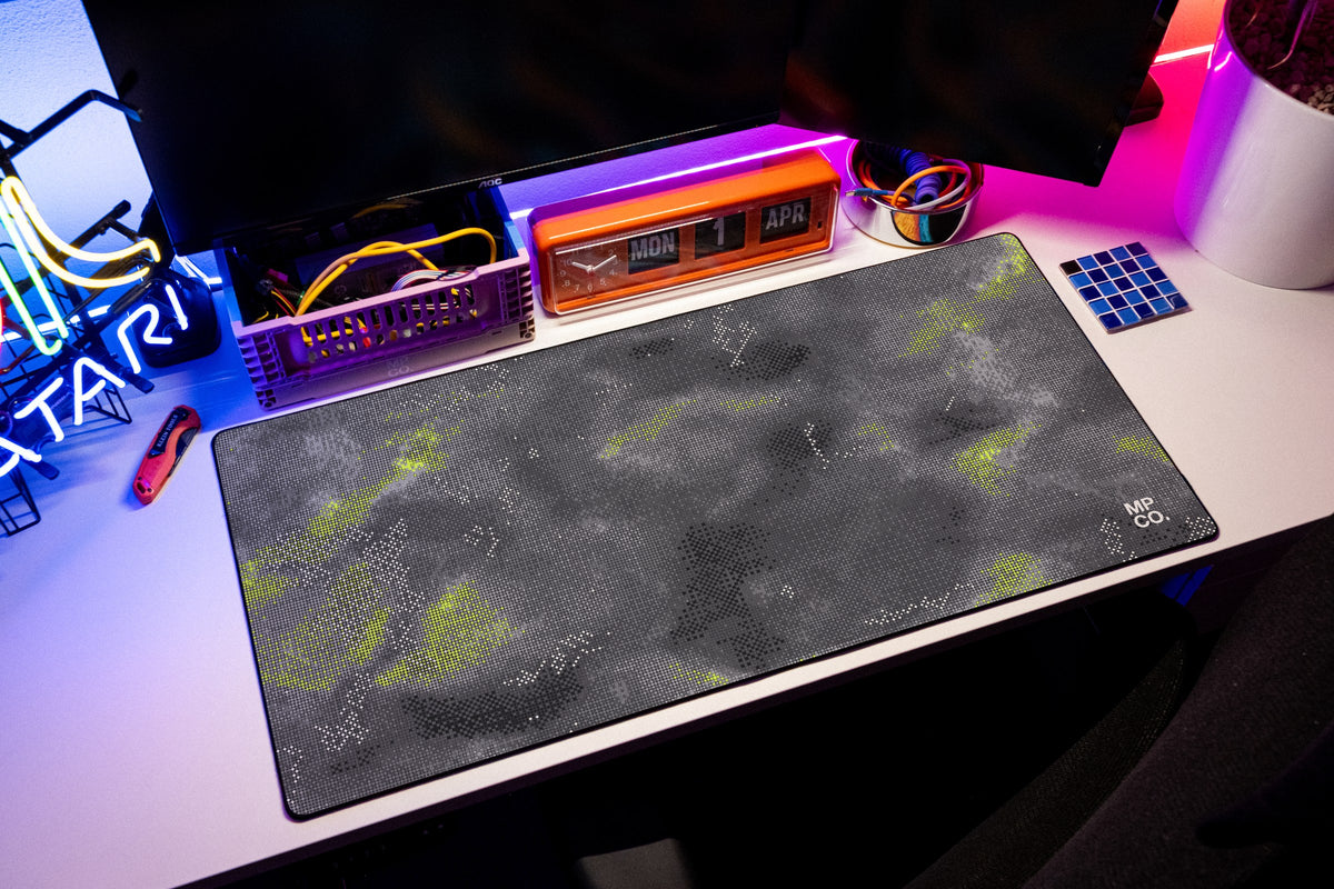 Stitch Grid desk mat in Graphite, shown on a styled desk setup