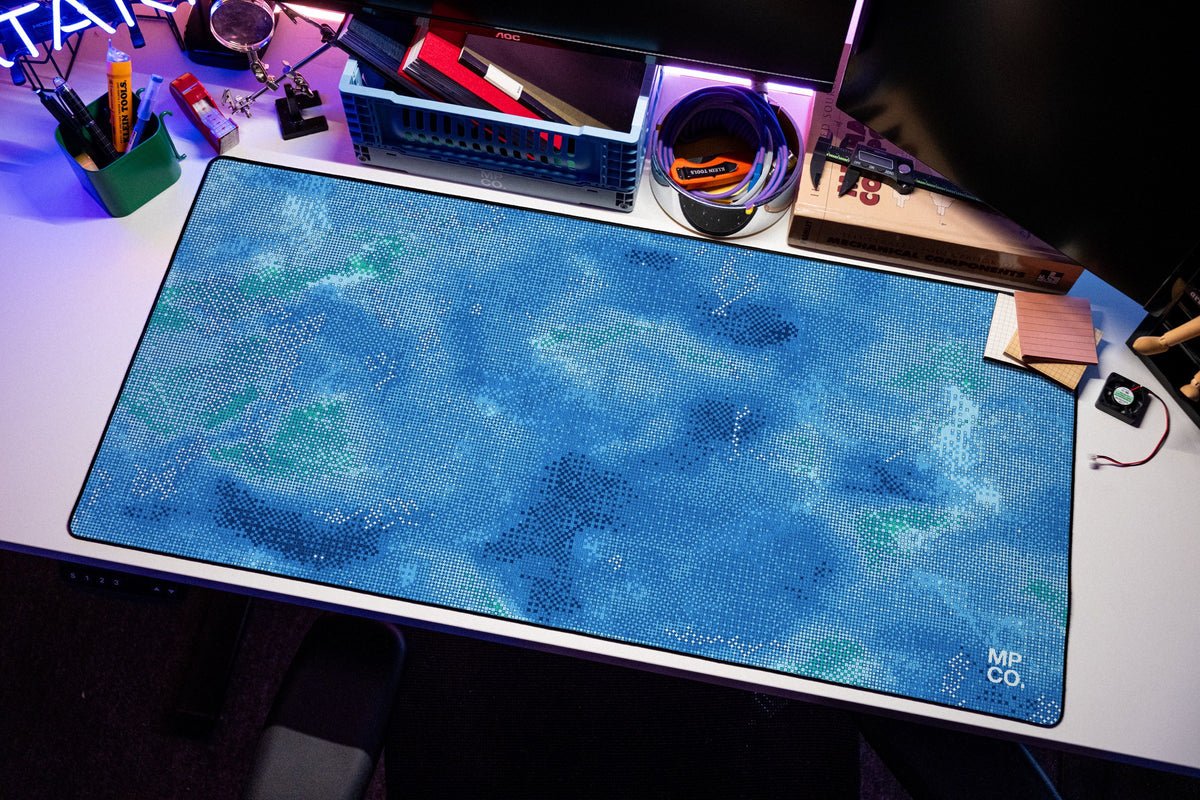 Stitch Grid desk mat in Lagoon, shown on a styled desk setup