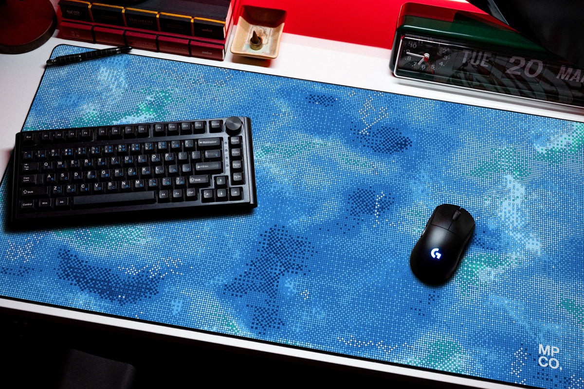 Stitch Grid desk mat in Lagoon, shown on a styled desk setup