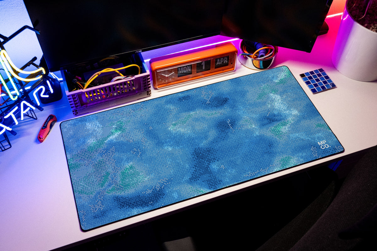 Stitch Grid desk mat in Lagoon, shown on a styled desk setup