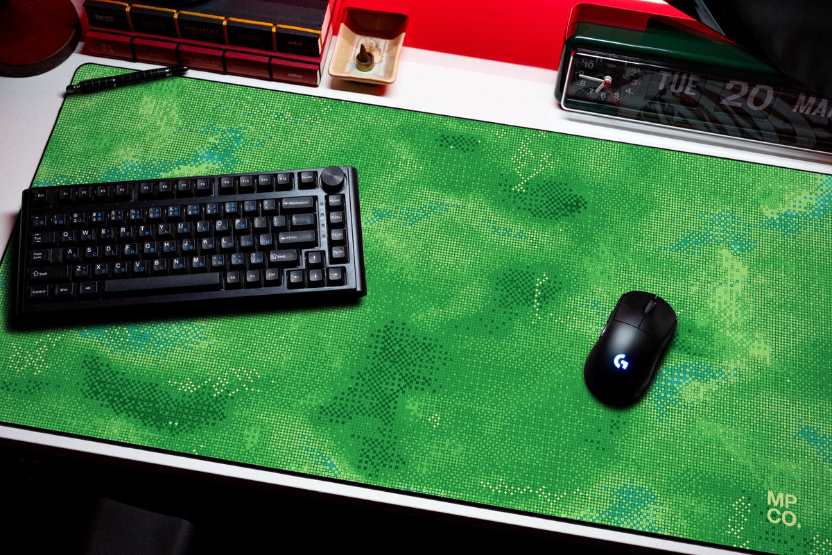 Stitch Grid desk mat in Moss, shown on a styled desk setup