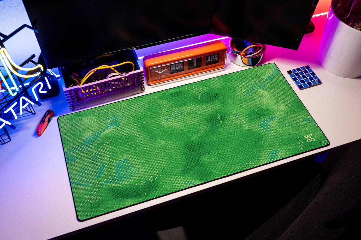 Stitch Grid desk mat in Moss, shown on a styled desk setup