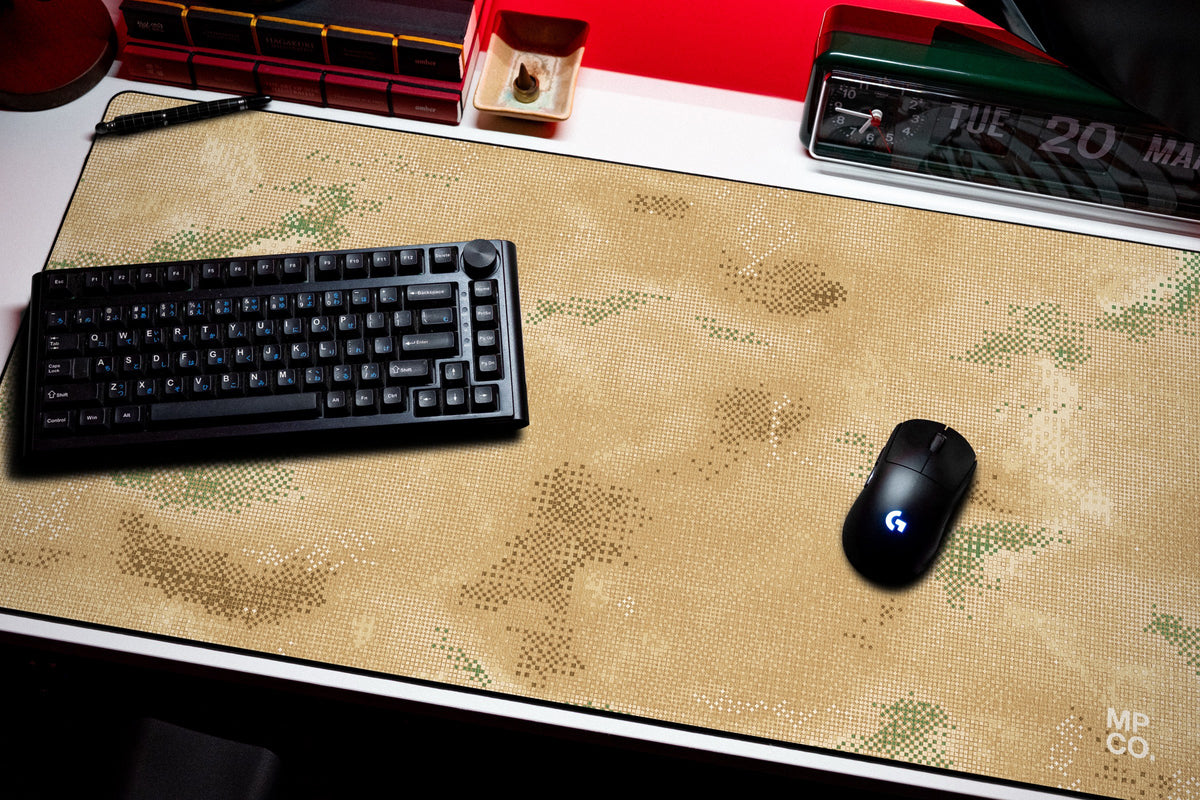 Stitch Grid desk mat in Sand, shown on a styled desk setup