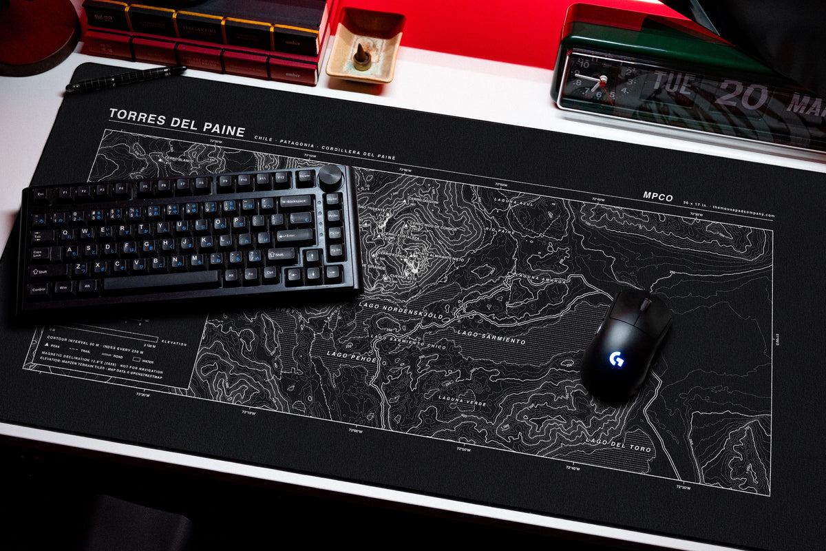 Torres del Paine Topo Pad desk mat in Black / White, shown on a styled desk setup
