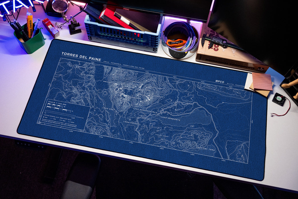 Torres del Paine Topo Pad desk mat in Blue / White, shown on a styled desk setup