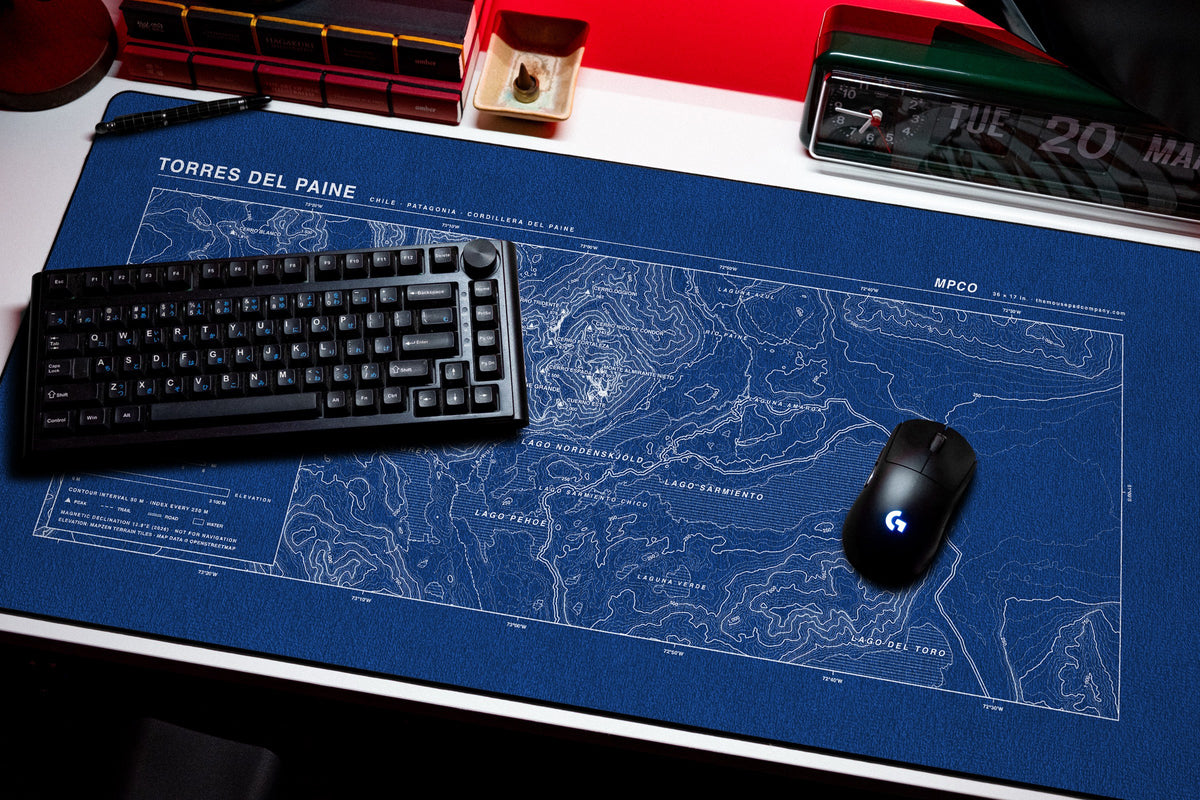 Torres del Paine Topo Pad desk mat in Blue / White, shown on a styled desk setup