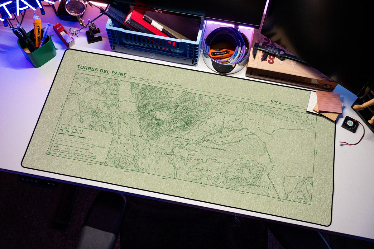 Torres del Paine Topo Pad desk mat in Buff / Green, shown on a styled desk setup