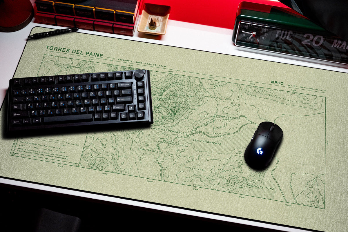 Torres del Paine Topo Pad desk mat in Buff / Green, shown on a styled desk setup