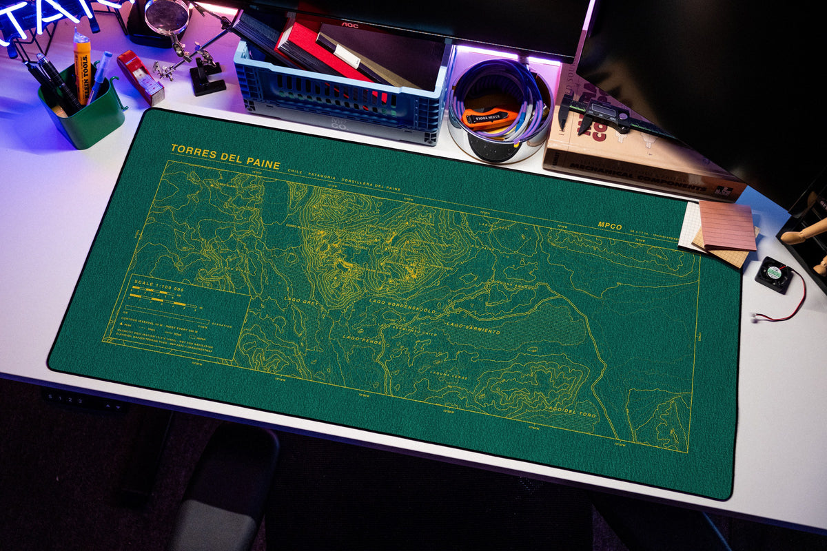 Torres del Paine Topo Pad desk mat in Green / Yellow, shown on a styled desk setup