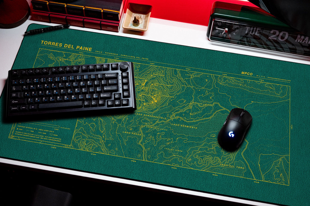 Torres del Paine Topo Pad desk mat in Green / Yellow, shown on a styled desk setup