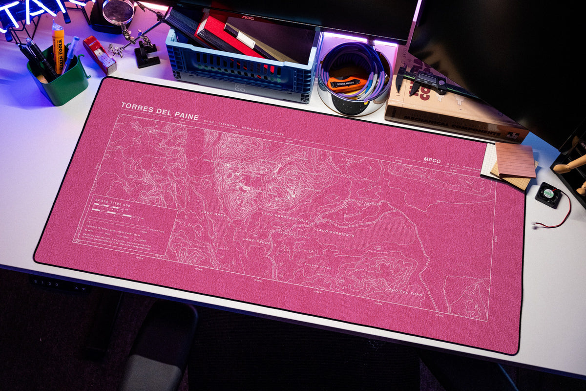 Torres del Paine Topo Pad desk mat in Pink / White, shown on a styled desk setup