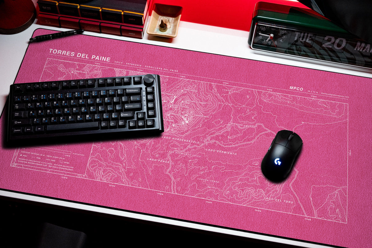 Torres del Paine Topo Pad desk mat in Pink / White, shown on a styled desk setup