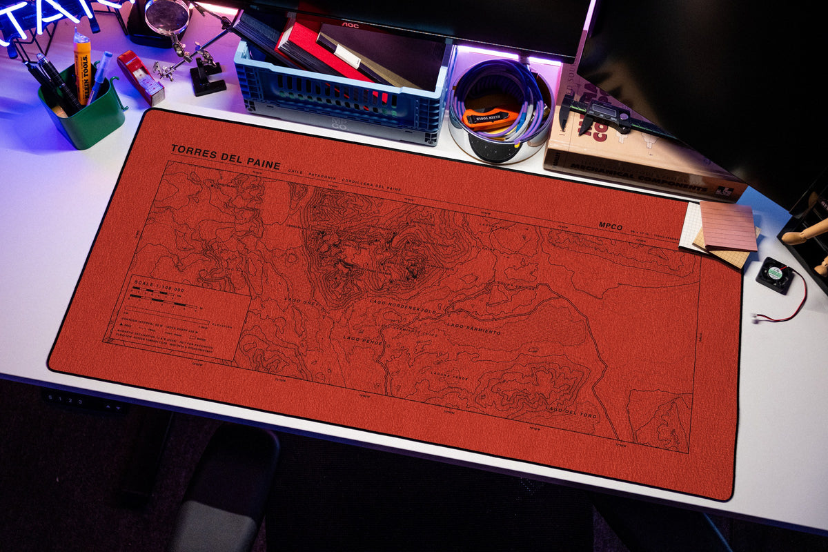 Torres del Paine Topo Pad desk mat in Red / Black, shown on a styled desk setup