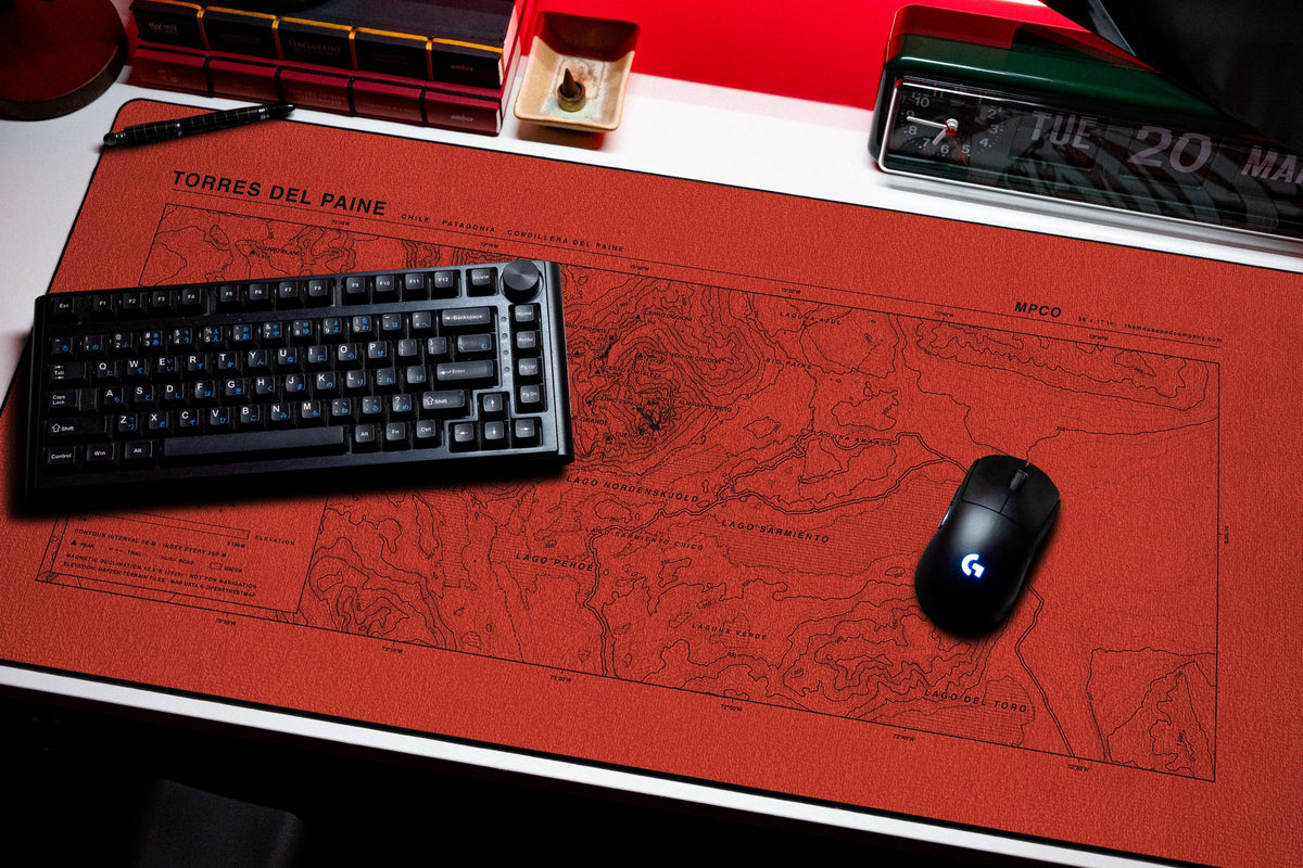 Torres del Paine Topo Pad desk mat in Red / Black, shown on a styled desk setup