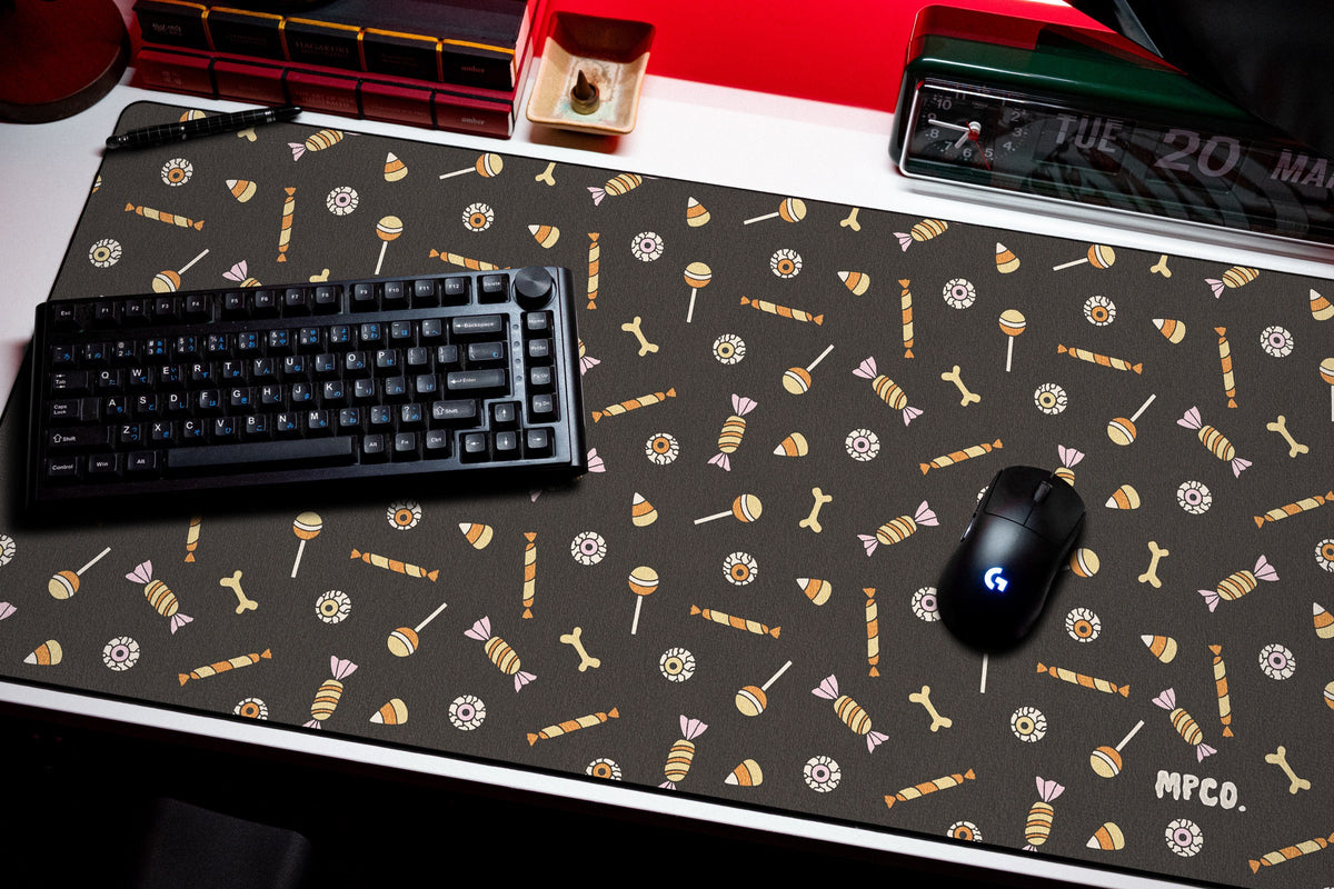 Trick or Treat desk mat in Black, shown on a styled desk setup