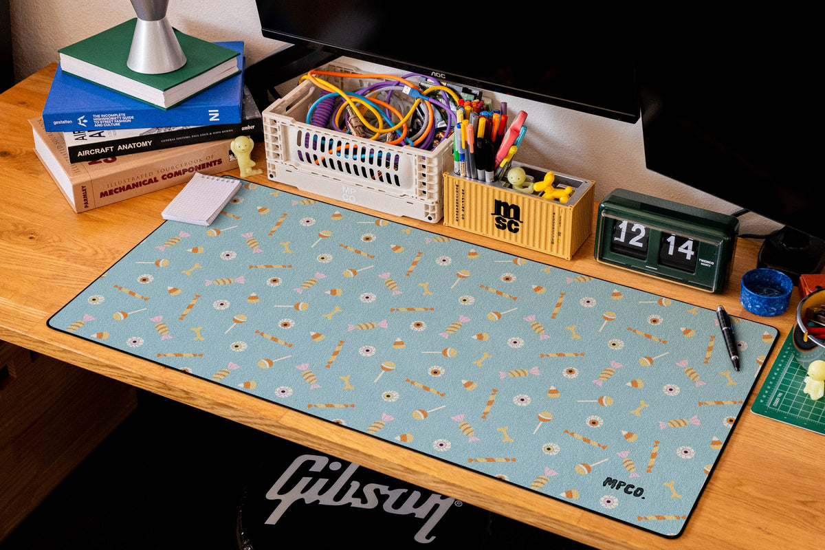 Trick or Treat desk mat in Blue, shown on a styled desk setup