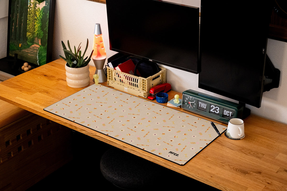 Trick or Treat desk mat in Cream, shown on a styled desk setup