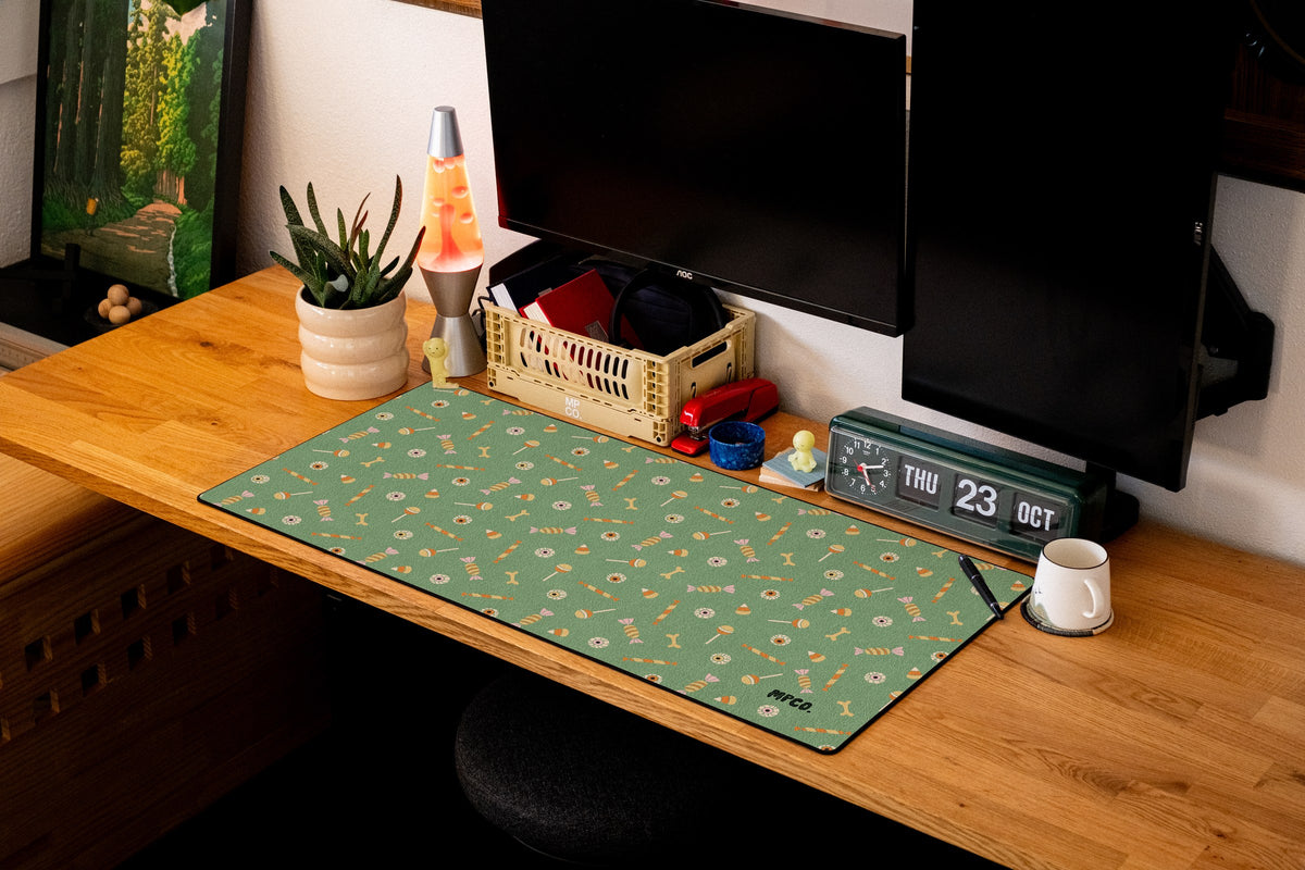 Trick or Treat desk mat in Green, shown on a styled desk setup
