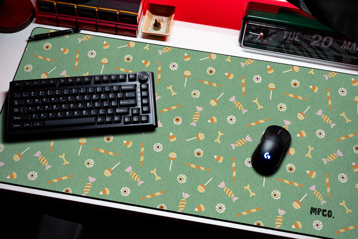 Trick or Treat desk mat in Green, shown on a styled desk setup