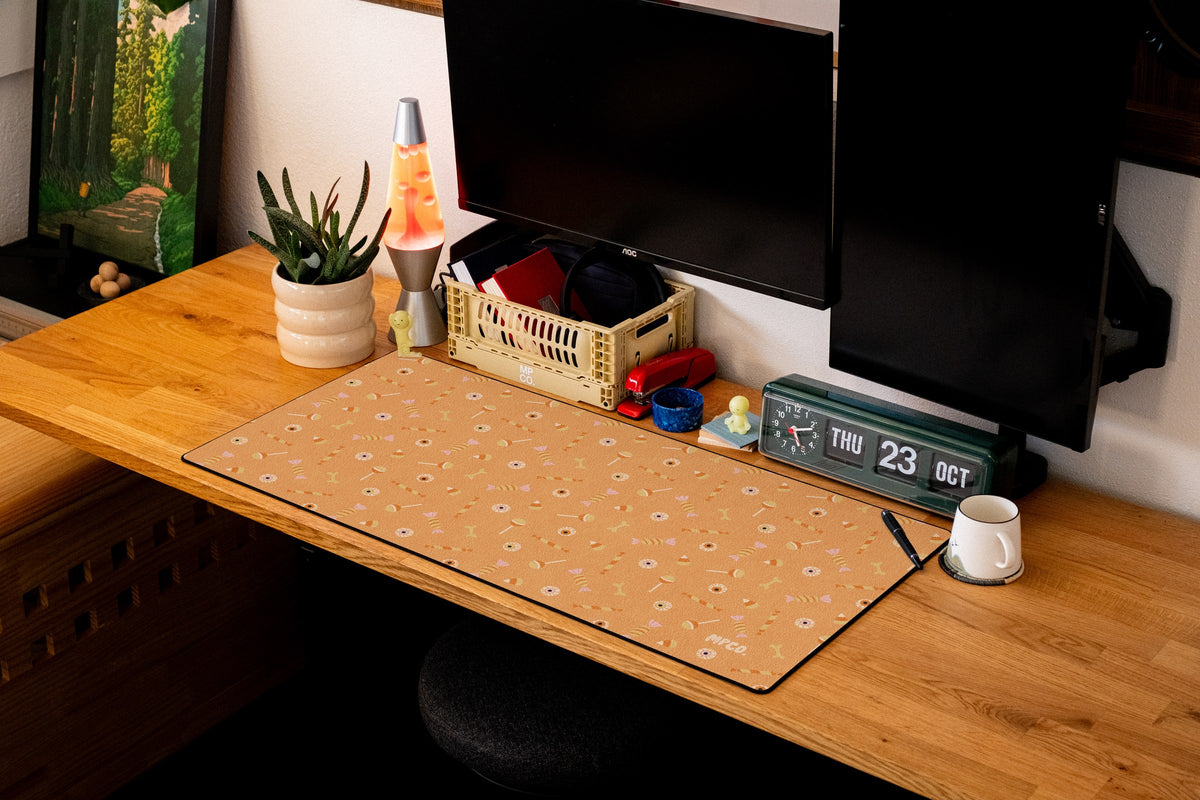 Trick or Treat desk mat in Orange, shown on a styled desk setup