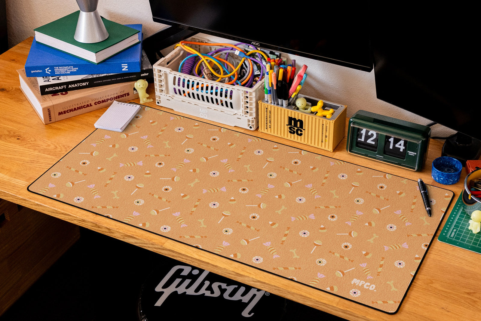 Trick or Treat desk mat in Orange, shown on a styled desk setup