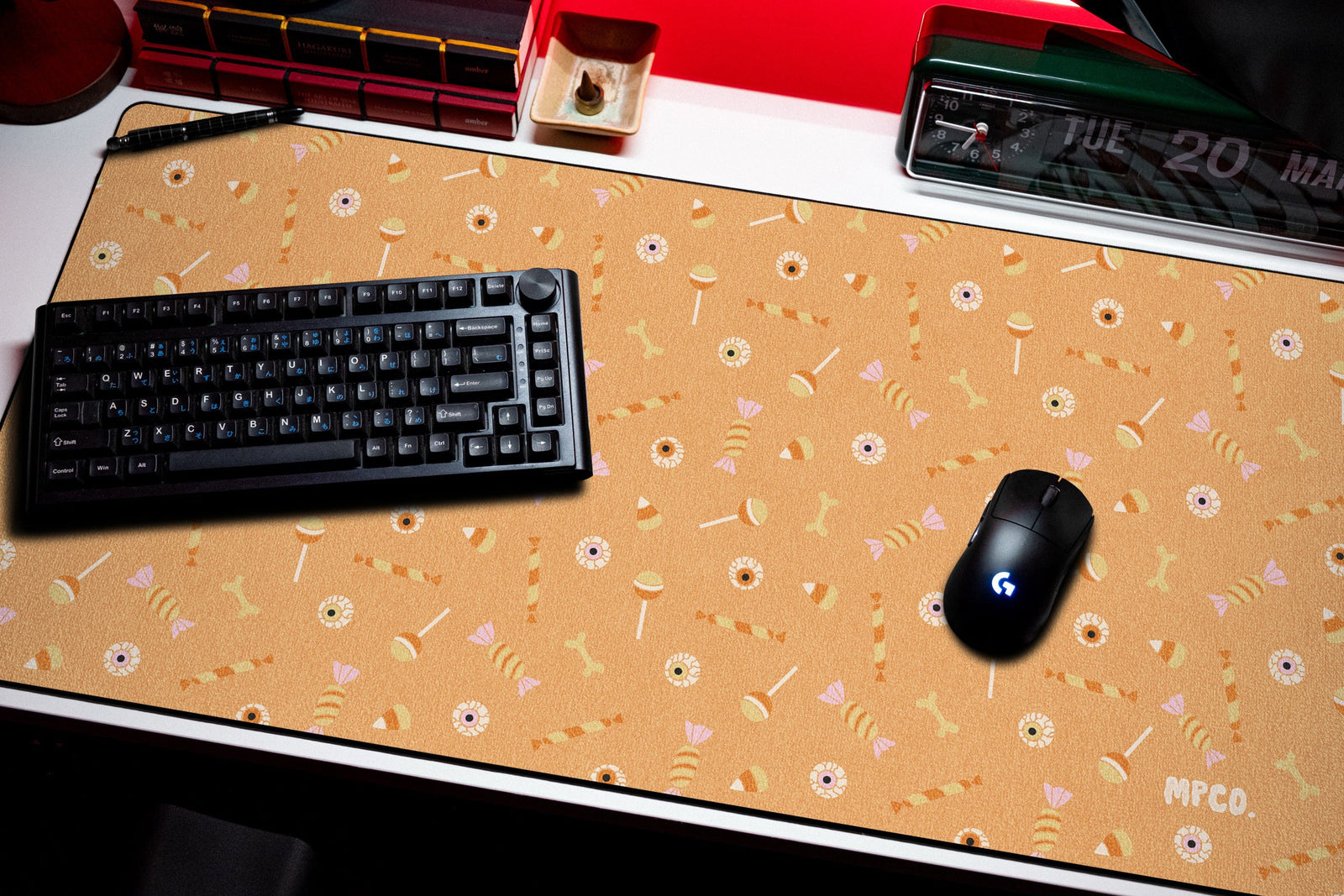 Trick or Treat desk mat in Orange, shown on a styled desk setup