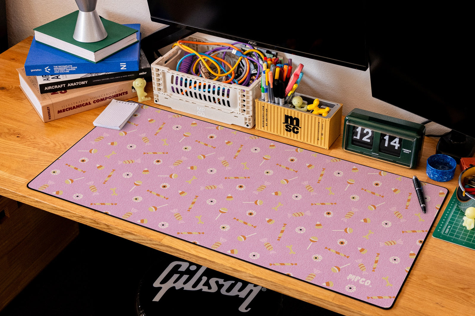Trick or Treat desk mat in Pink, shown on a styled desk setup