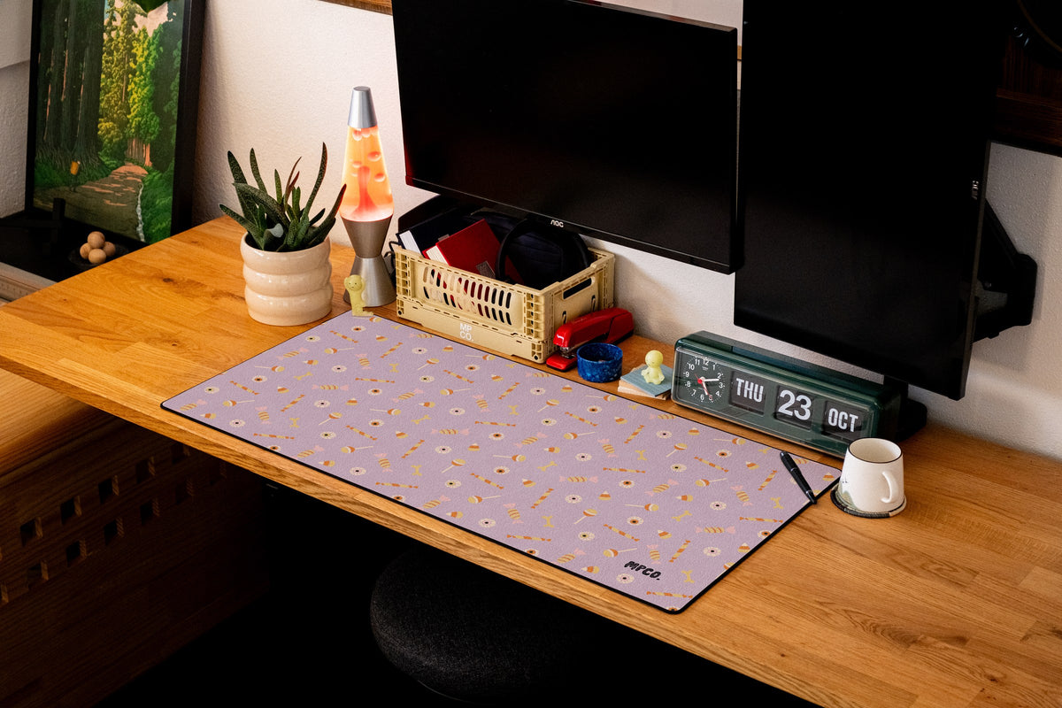 Trick or Treat desk mat in Purple, shown on a styled desk setup
