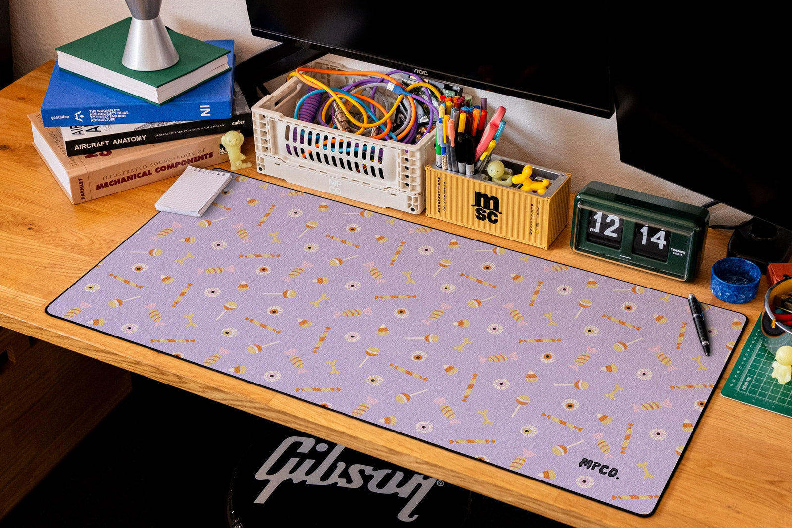 Trick or Treat desk mat in Purple, shown on a styled desk setup