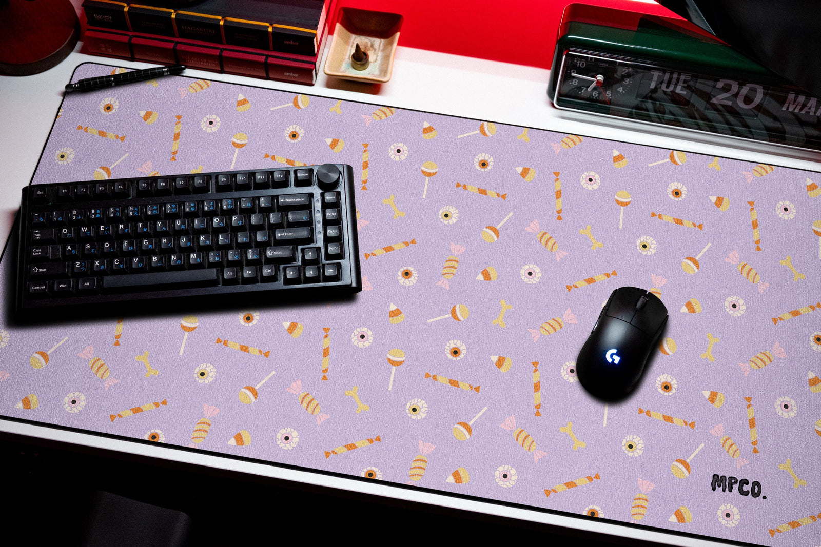 Trick or Treat desk mat in Purple, shown on a styled desk setup