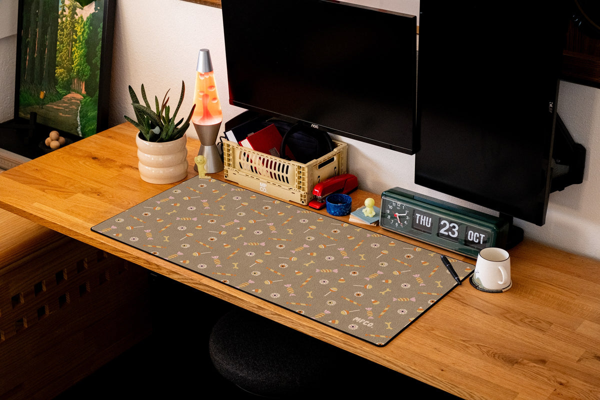 Trick or Treat desk mat in Sand, shown on a styled desk setup