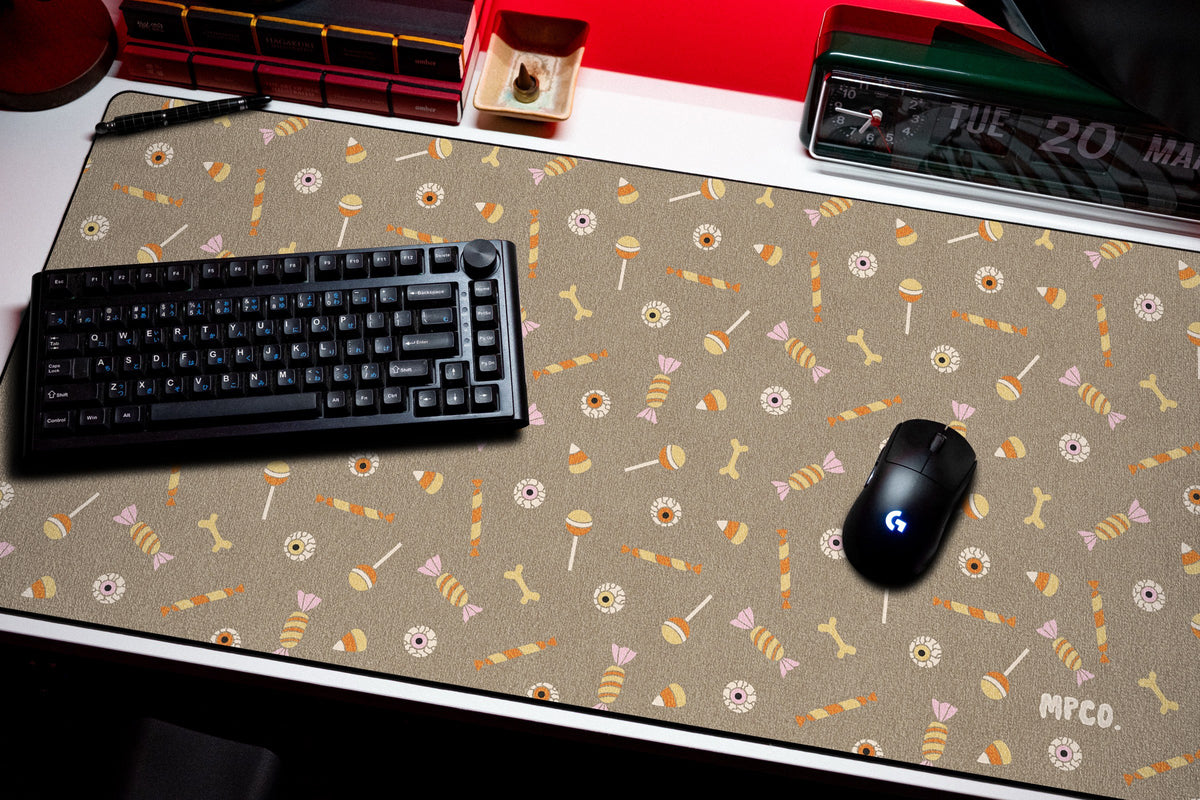 Trick or Treat desk mat in Sand, shown on a styled desk setup