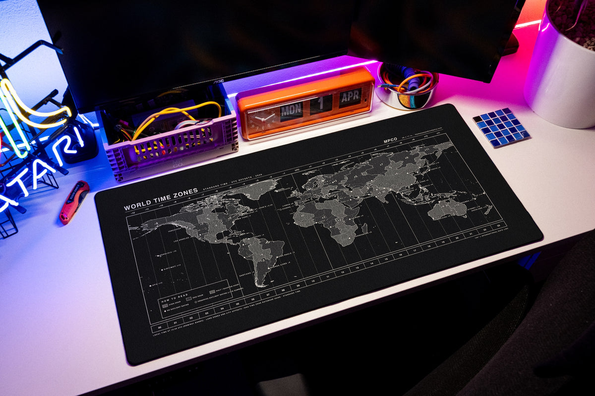 World Time Zones Map Pad desk mat in Black / White, shown on a styled desk setup