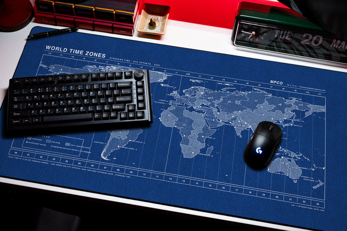 World Time Zones Map Pad desk mat in Blue / White, shown on a styled desk setup