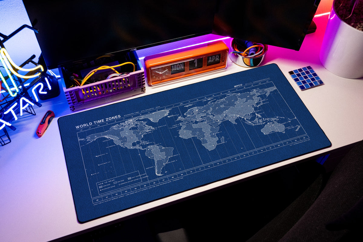 World Time Zones Map Pad desk mat in Blue / White, shown on a styled desk setup