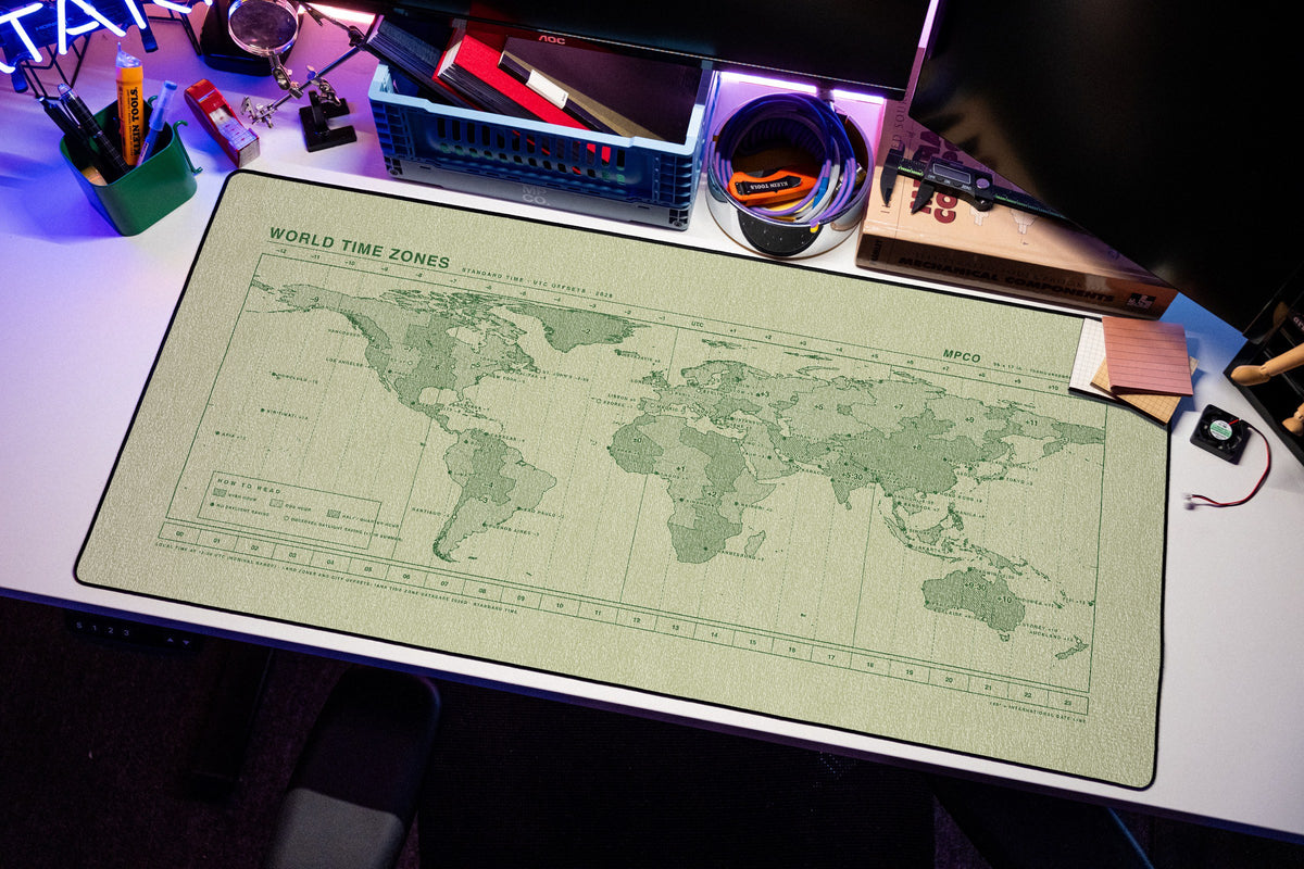 World Time Zones Map Pad desk mat in Buff / Green, shown on a styled desk setup