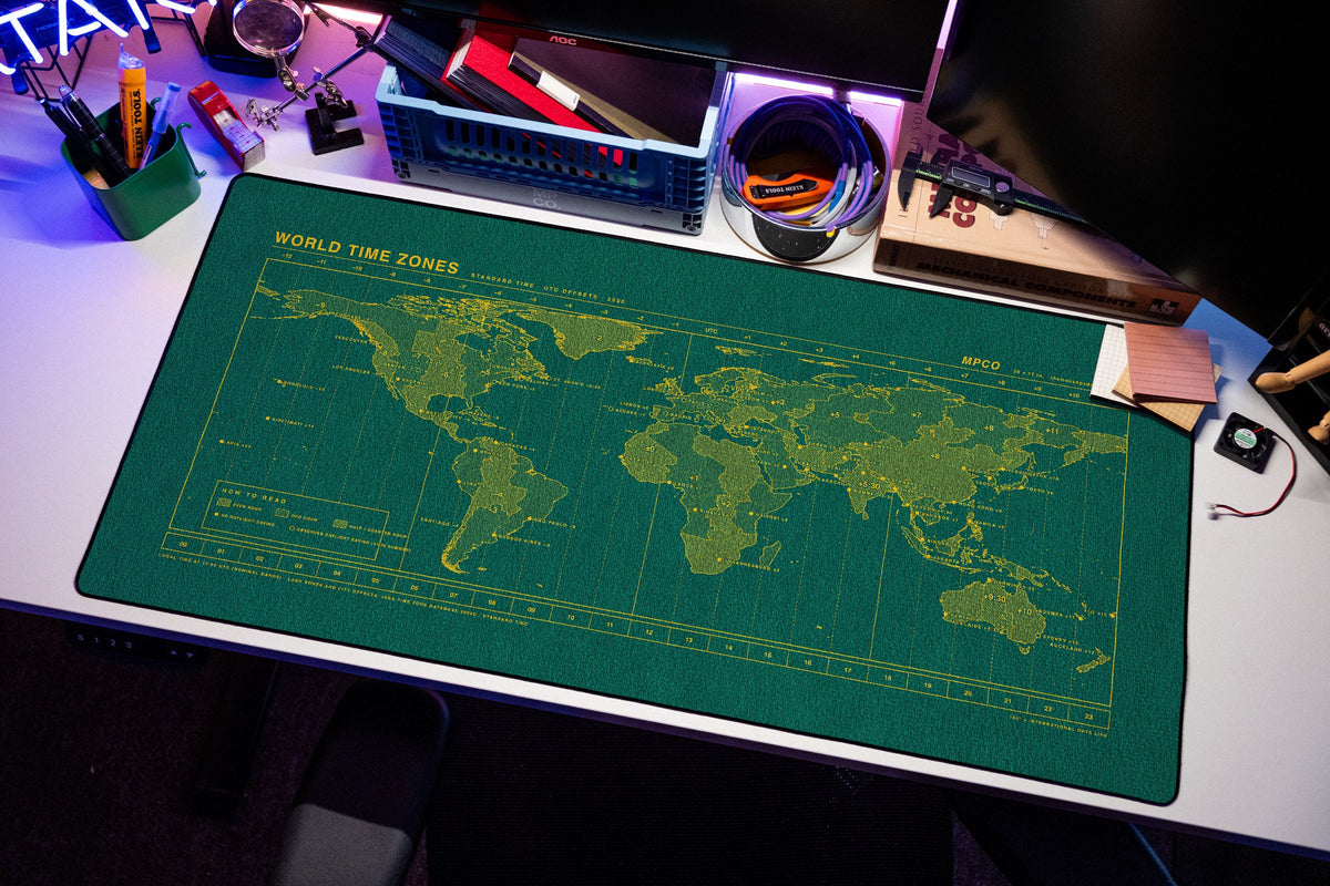 World Time Zones Map Pad desk mat in Green / Yellow, shown on a styled desk setup